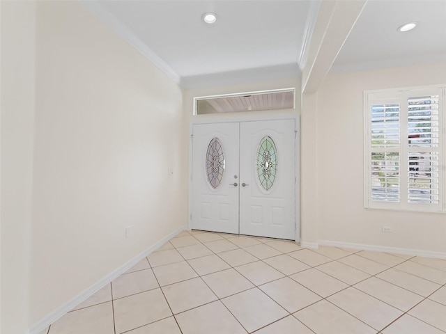 entryway with ornamental molding and light tile patterned flooring