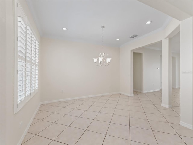 empty room featuring an inviting chandelier, crown molding, and light tile patterned floors