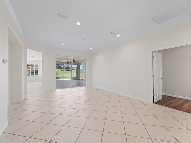 spare room with light tile patterned floors, ornamental molding, and ceiling fan