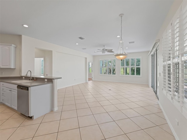 kitchen featuring pendant lighting, white cabinetry, dishwasher, sink, and light tile patterned floors