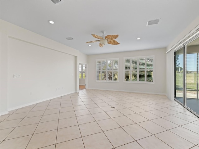 empty room featuring light tile patterned flooring and ceiling fan