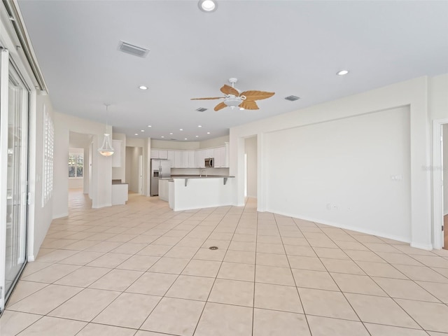 unfurnished living room with ceiling fan