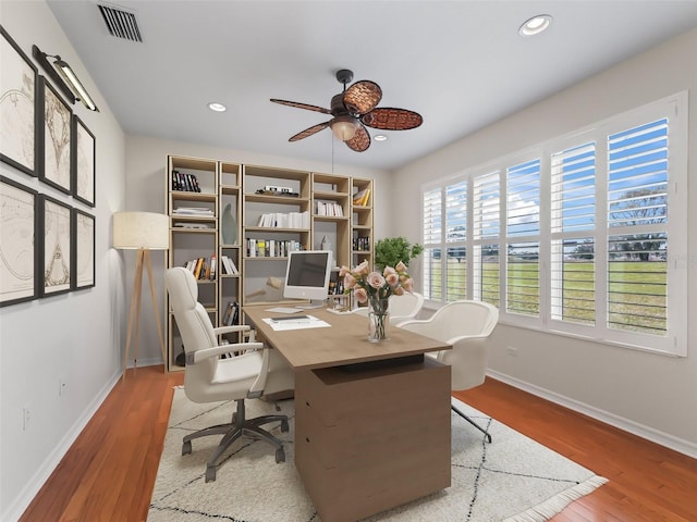 office with wood-type flooring and ceiling fan