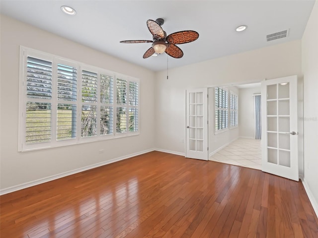 unfurnished room with ceiling fan and light wood-type flooring