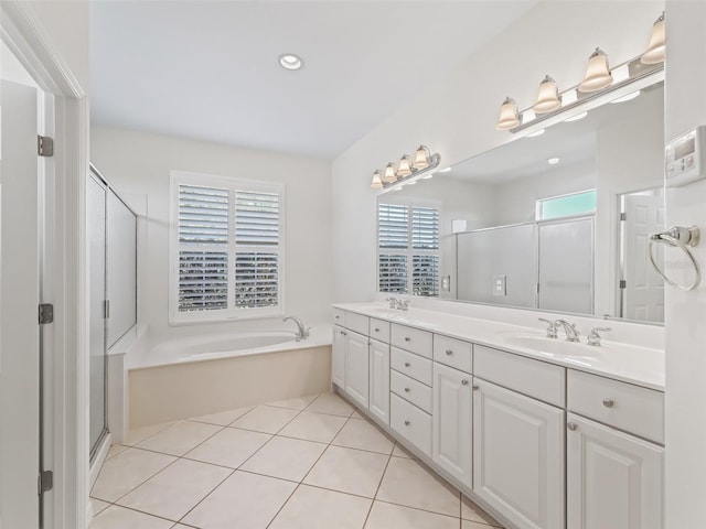 bathroom with independent shower and bath, vanity, and tile patterned floors