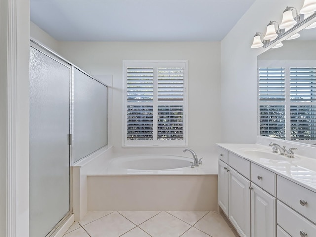 bathroom with a healthy amount of sunlight, vanity, and tile patterned flooring