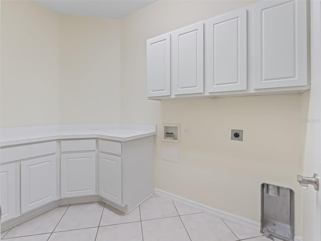 washroom with light tile patterned flooring, cabinets, washer hookup, and electric dryer hookup