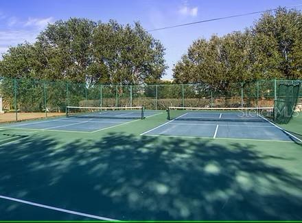 view of tennis court with fence