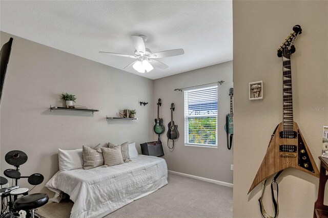 bedroom featuring ceiling fan, baseboards, and light colored carpet