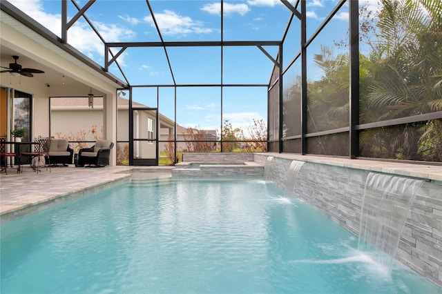 view of swimming pool featuring a ceiling fan, a patio, a lanai, a pool with connected hot tub, and an outdoor living space