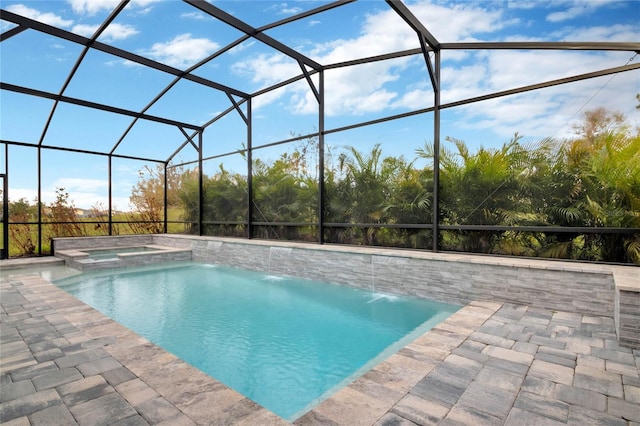 view of pool with a lanai, a pool with connected hot tub, and a patio