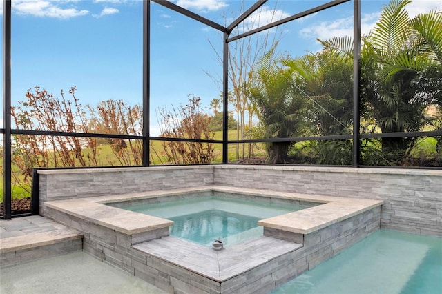 view of pool with an in ground hot tub, a lanai, and a pool