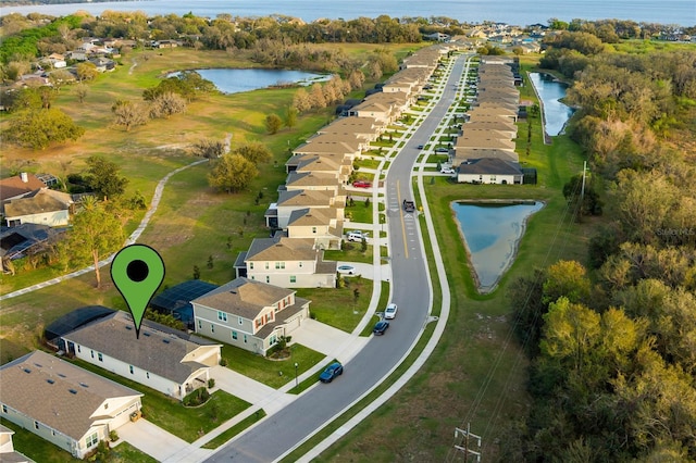 birds eye view of property with a water view and a residential view