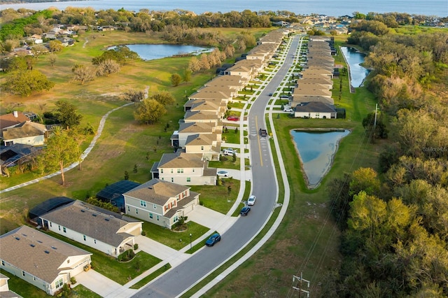 drone / aerial view with a water view and a residential view