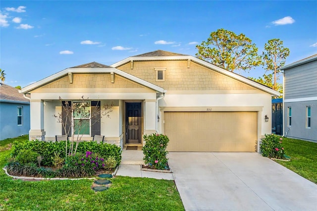 view of front facade featuring a garage, a front yard, concrete driveway, and stucco siding