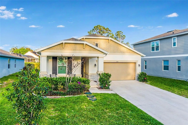 view of front of house featuring a garage, a front yard, driveway, and stucco siding