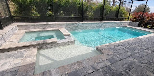 view of swimming pool with glass enclosure and a pool with connected hot tub