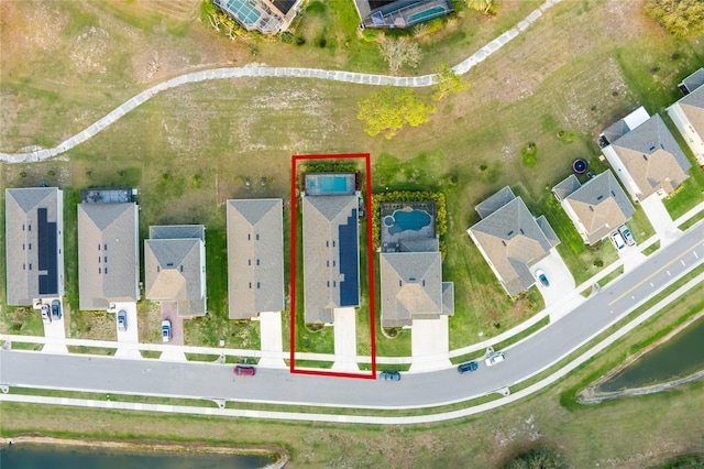 bird's eye view featuring a residential view and a water view