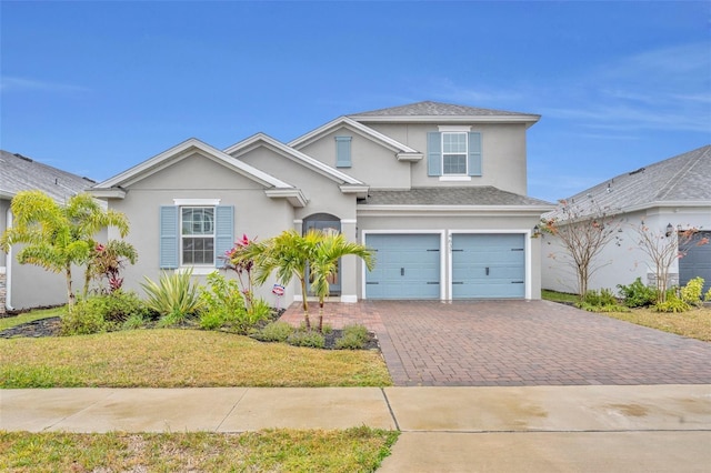 view of property with a garage and a front yard