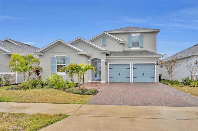 view of property with a garage and a front yard