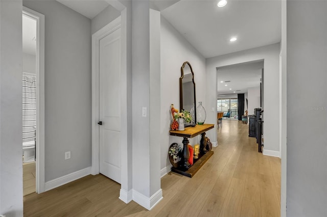 hallway with light hardwood / wood-style floors