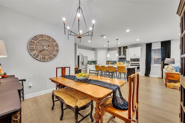 dining room with a chandelier and light hardwood / wood-style floors