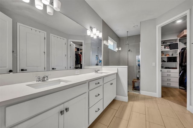 bathroom featuring a tile shower and vanity