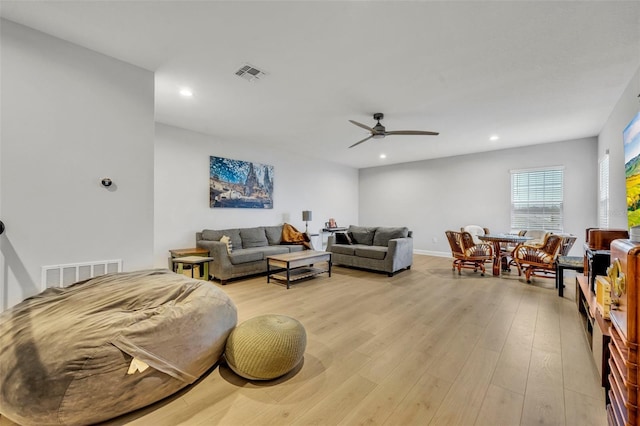 living room with ceiling fan and light wood-type flooring