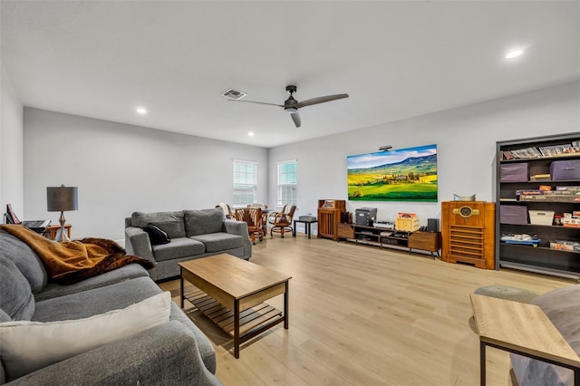 living room featuring ceiling fan and light hardwood / wood-style floors