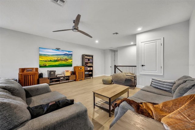 living room featuring ceiling fan and light hardwood / wood-style flooring