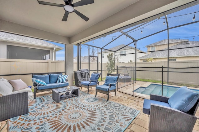 sunroom / solarium featuring ceiling fan