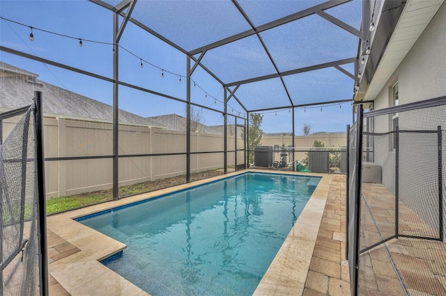 view of swimming pool featuring a lanai and a patio