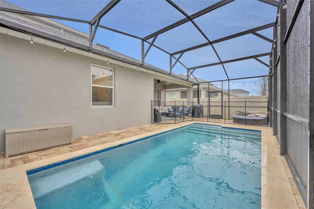 view of swimming pool featuring a lanai and a patio