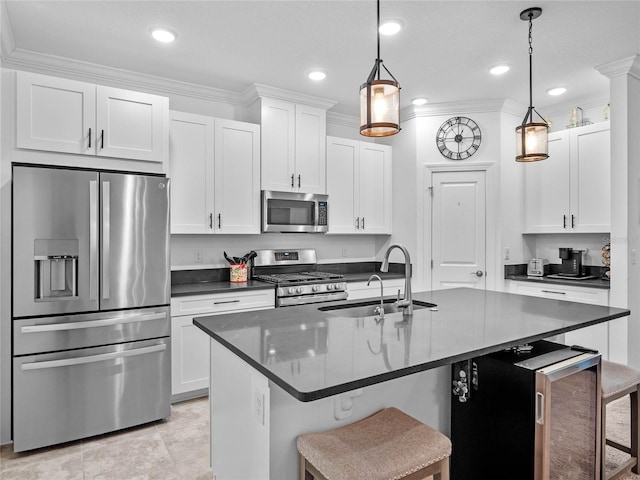 kitchen with pendant lighting, sink, stainless steel appliances, and a kitchen bar