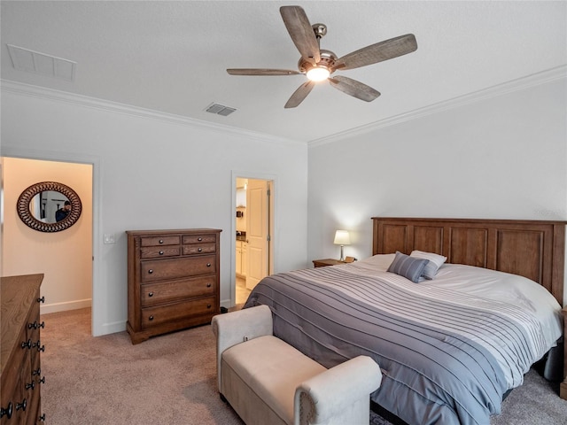 bedroom with crown molding, light carpet, ceiling fan, and ensuite bath