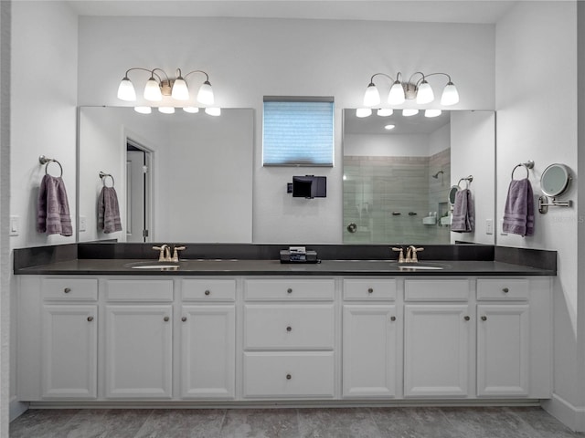 bathroom with vanity and tiled shower