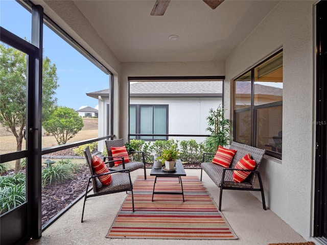 sunroom / solarium featuring ceiling fan