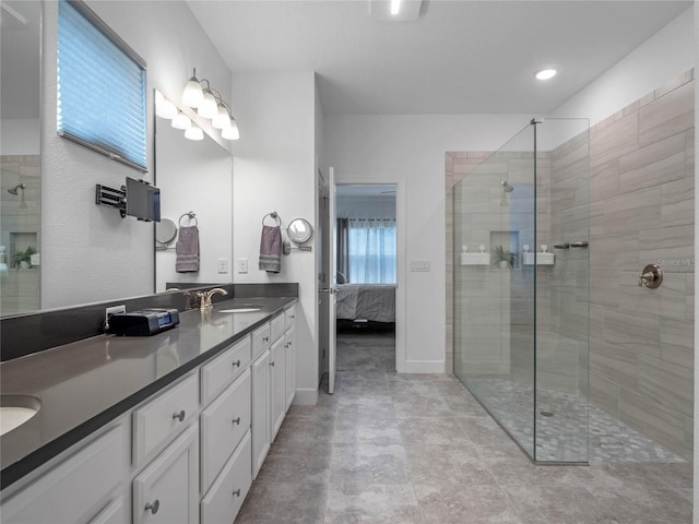 bathroom featuring vanity and a shower with door