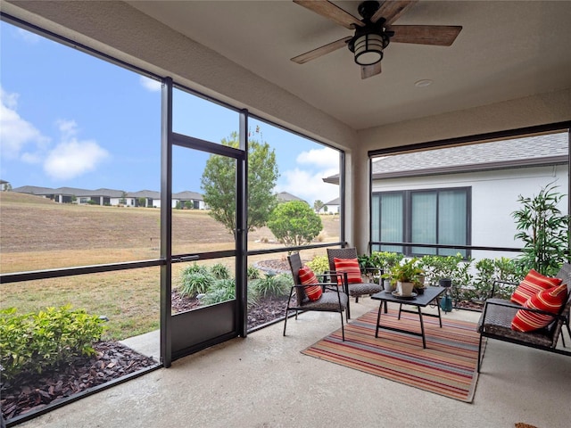 sunroom / solarium featuring ceiling fan