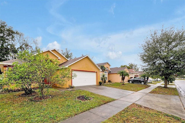 view of front of house with a garage and a front lawn