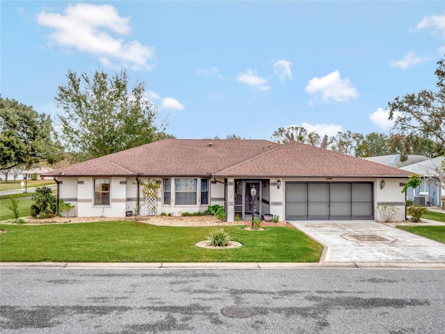 single story home featuring a garage and a front lawn