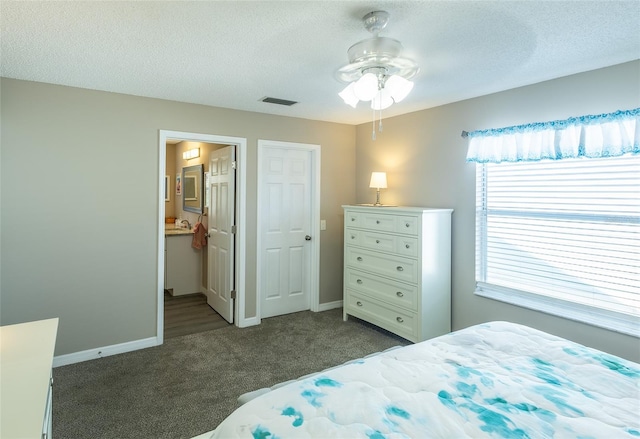 502 San Marino Dr, Lady Lake, FL 32159 - carpeted bedroom with a textured ceiling, ensuite bathroom, and ceiling fan