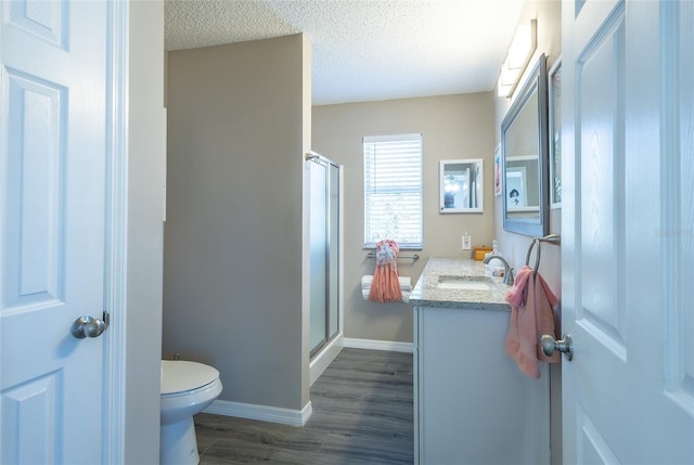 502 San Marino Dr, Lady Lake, FL 32159 - bathroom featuring hardwood / wood-style flooring, a shower, toilet, a textured ceiling, and vanity
