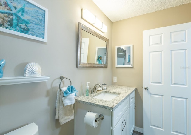 502 San Marino Dr, Lady Lake, FL 32159 - bathroom featuring vanity, toilet, and a textured ceiling