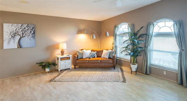 sitting room with vaulted ceiling, light wood-type flooring, and ceiling fan