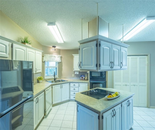 kitchen with white cabinetry, sink, and black appliances