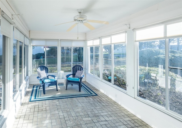 unfurnished sunroom featuring ceiling fan