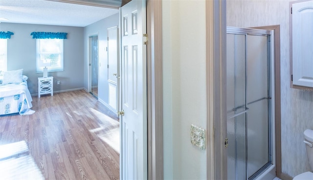 interior space featuring a textured ceiling and light wood-type flooring