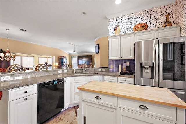 kitchen featuring white cabinets, dishwasher, stainless steel fridge, and wooden counters