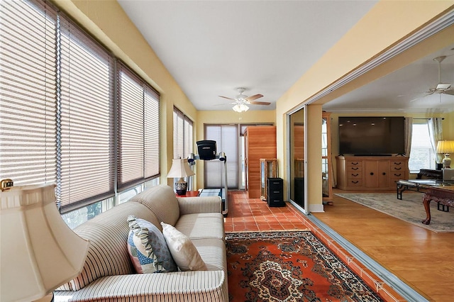 living room featuring light hardwood / wood-style flooring and ceiling fan